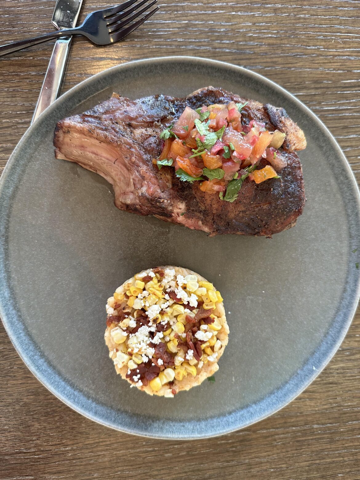 Sous vide bone in pork chop, peach relish, elote risotto