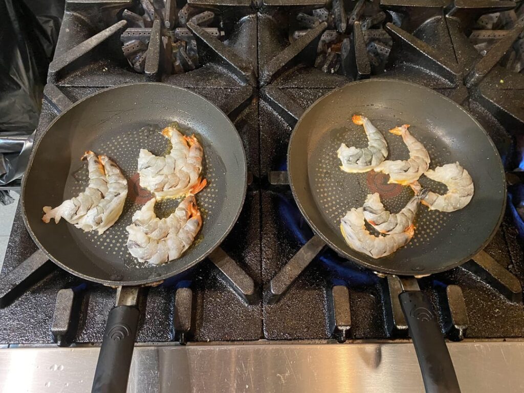 Sear shrimp in pairs for a straighter finish