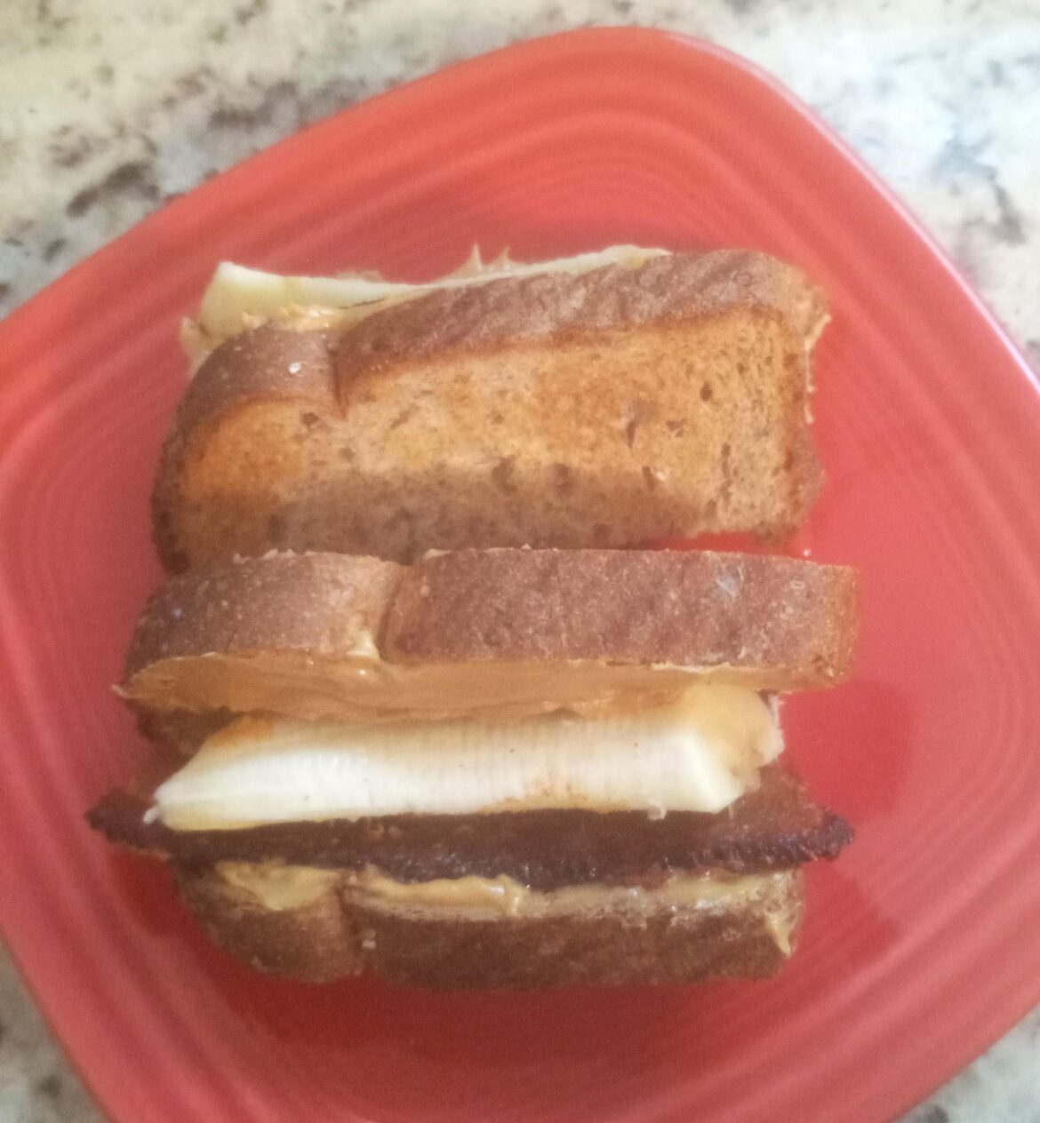 Peanut Butter, Thick Bacon, Banana, Hot Honey, a sprinkle of Tajin, Toasted Whole Grain for breakfast this morning