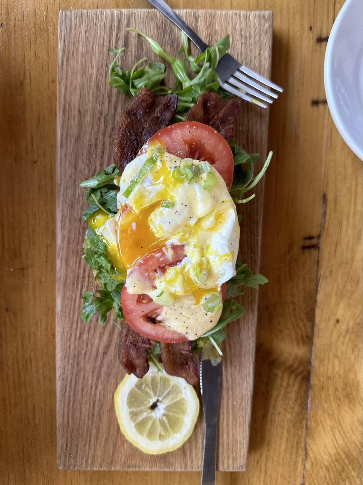 Runny yolk and tomatoes all over the table.