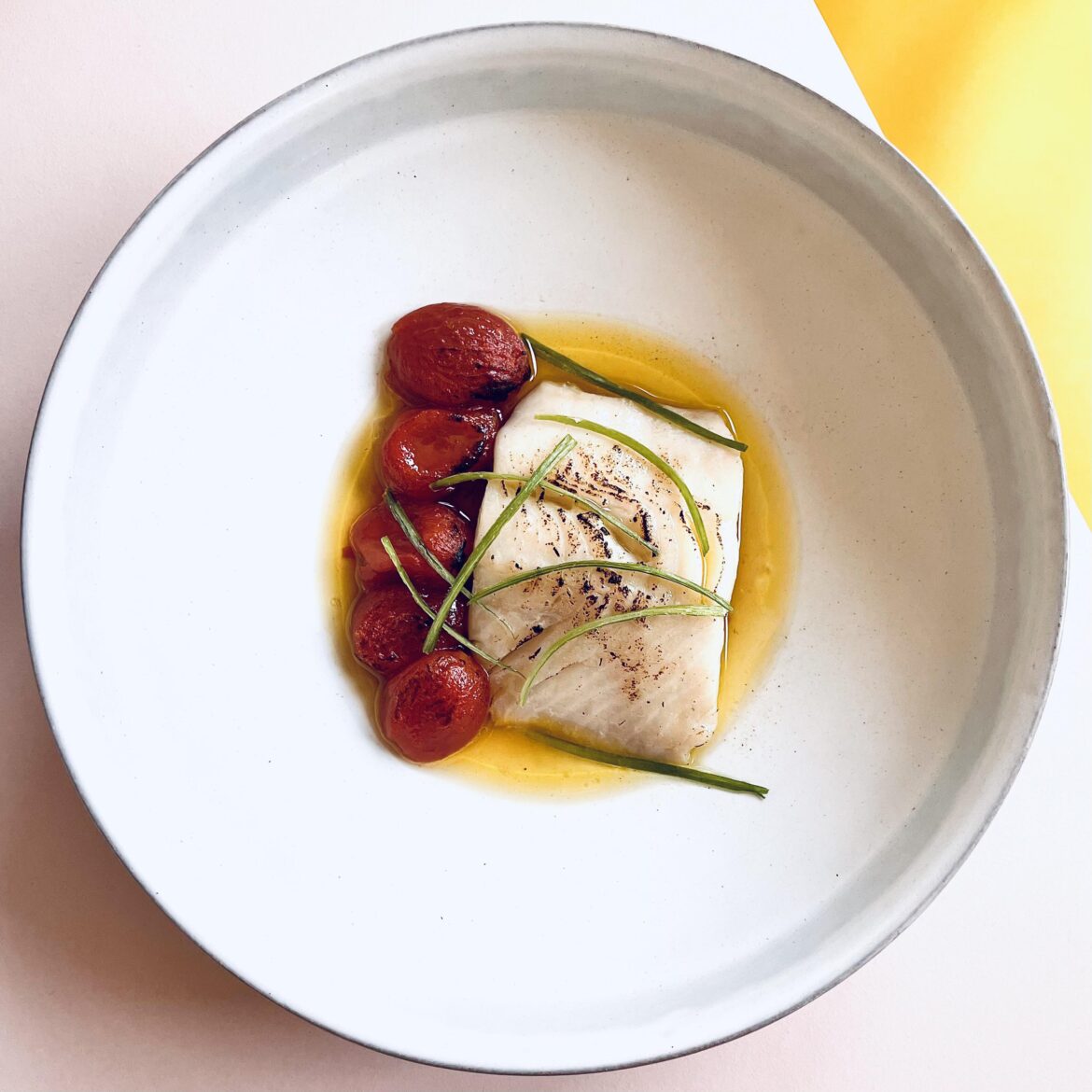 Black cod cooked sous vide in olive oil from a cherry tomato confit and then pan seared, served with tomato confit and dressed in a sauce comprised of lime juice, fish sauce, and sugar.