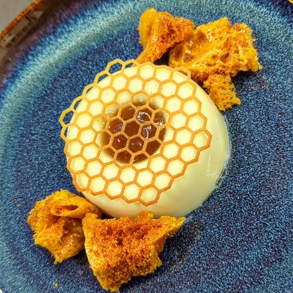 Honey panna cotta, pear vanilla caramel, honey tuile and honeycomb