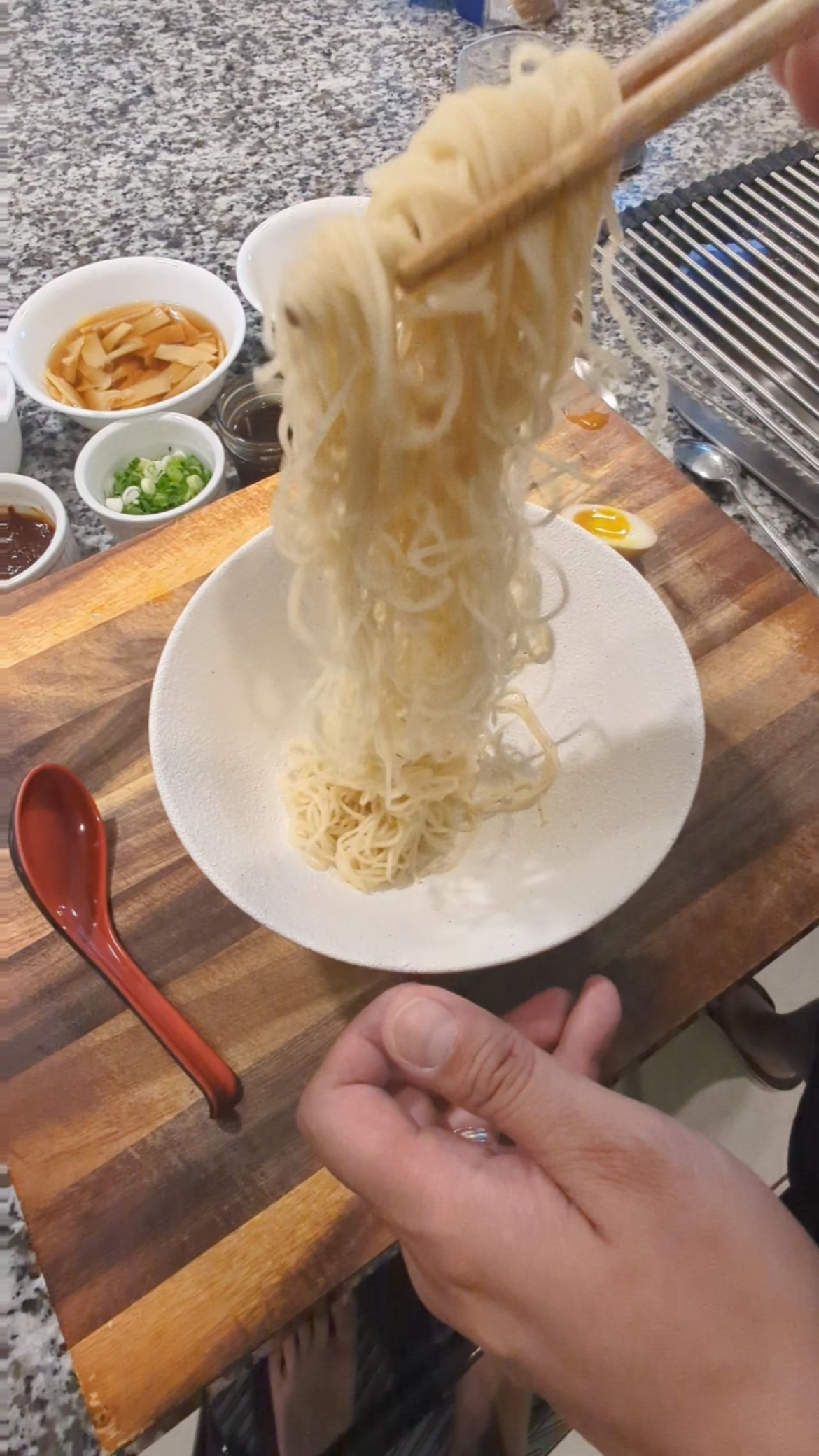 Assembling a homemade miso tonkotsu ramen.