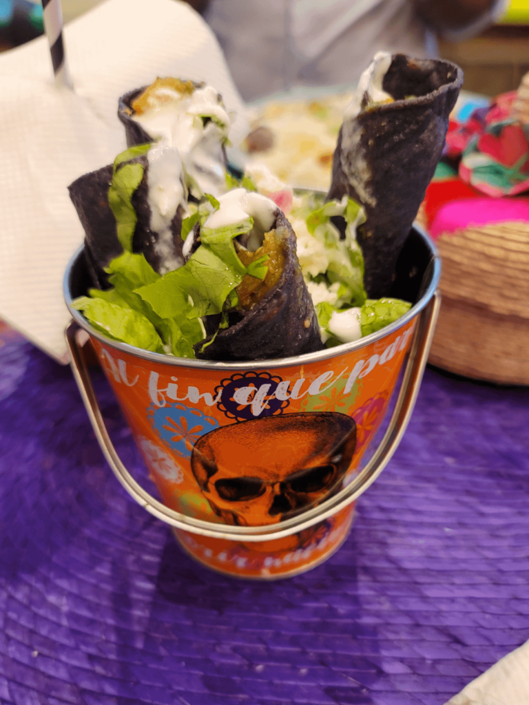 My flautas de pollo in a bucket.