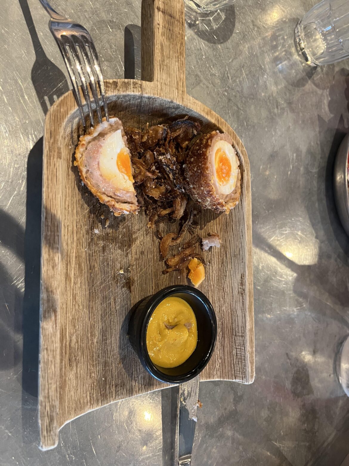 This isn’t just a spade being used as a plate. It’s a piece of would, carved in the shape of a spade without any of the practical applications just so it can be used instead of a plate.