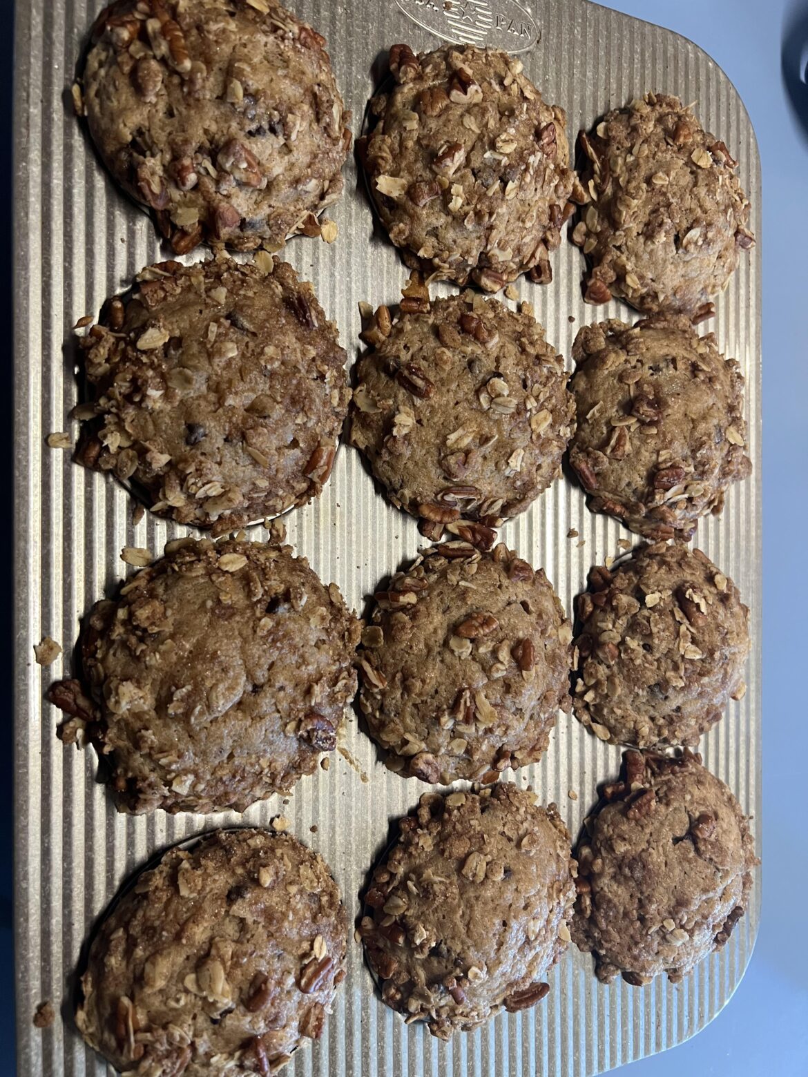 Banana cinnamon chocolate chip muffins with a snicker streusel top [Bravetart]
