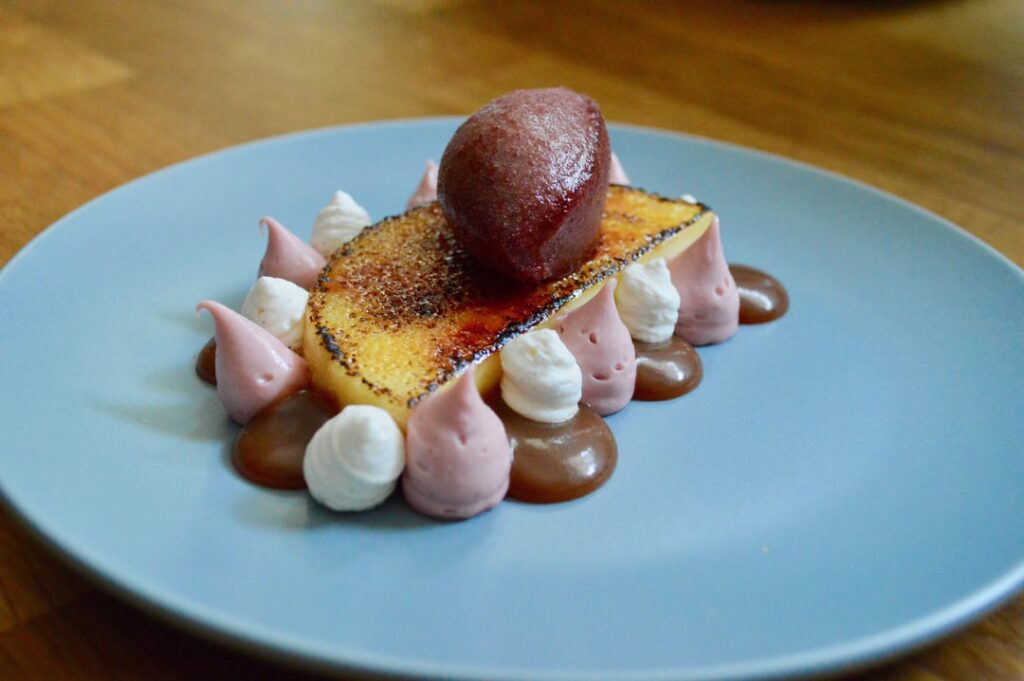 Lemon Brulee Tart, Ruby Chocolate Cremeux, Creme Chantilly, Salted Caramel, Black Cherry Sorbet