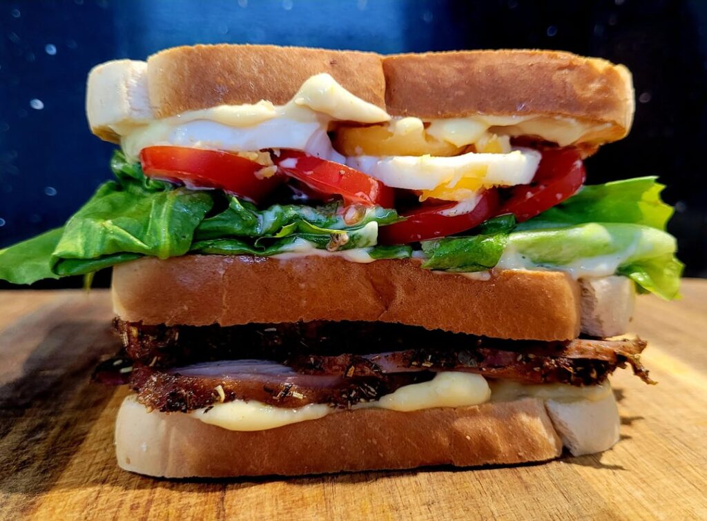 Club sandwich with turkey breast, homegrown lettuce, tomatoes and egg