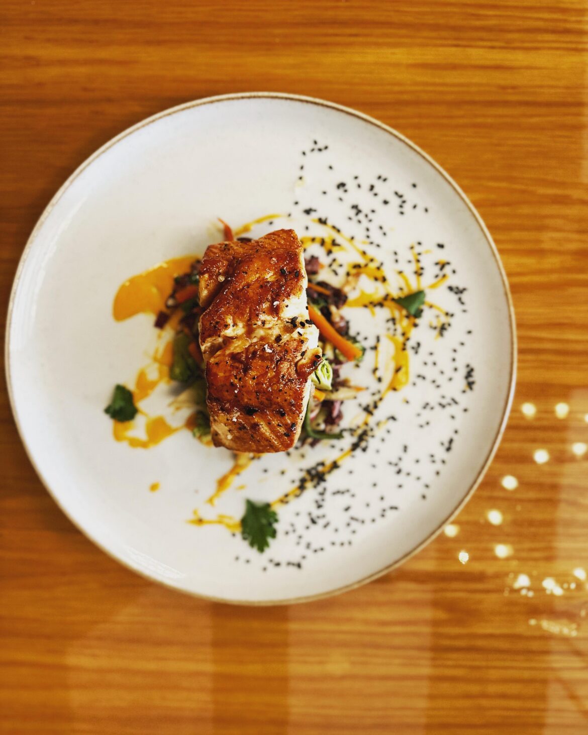 Sticky Asian Salmon, Coriander soy glaze, Asian slaw, gochujang aoli, black sesame, coriander leaf