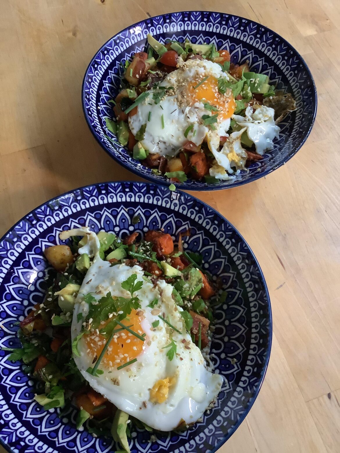 Yam and potato bacon hash, with avocado , tomato and a sunny.