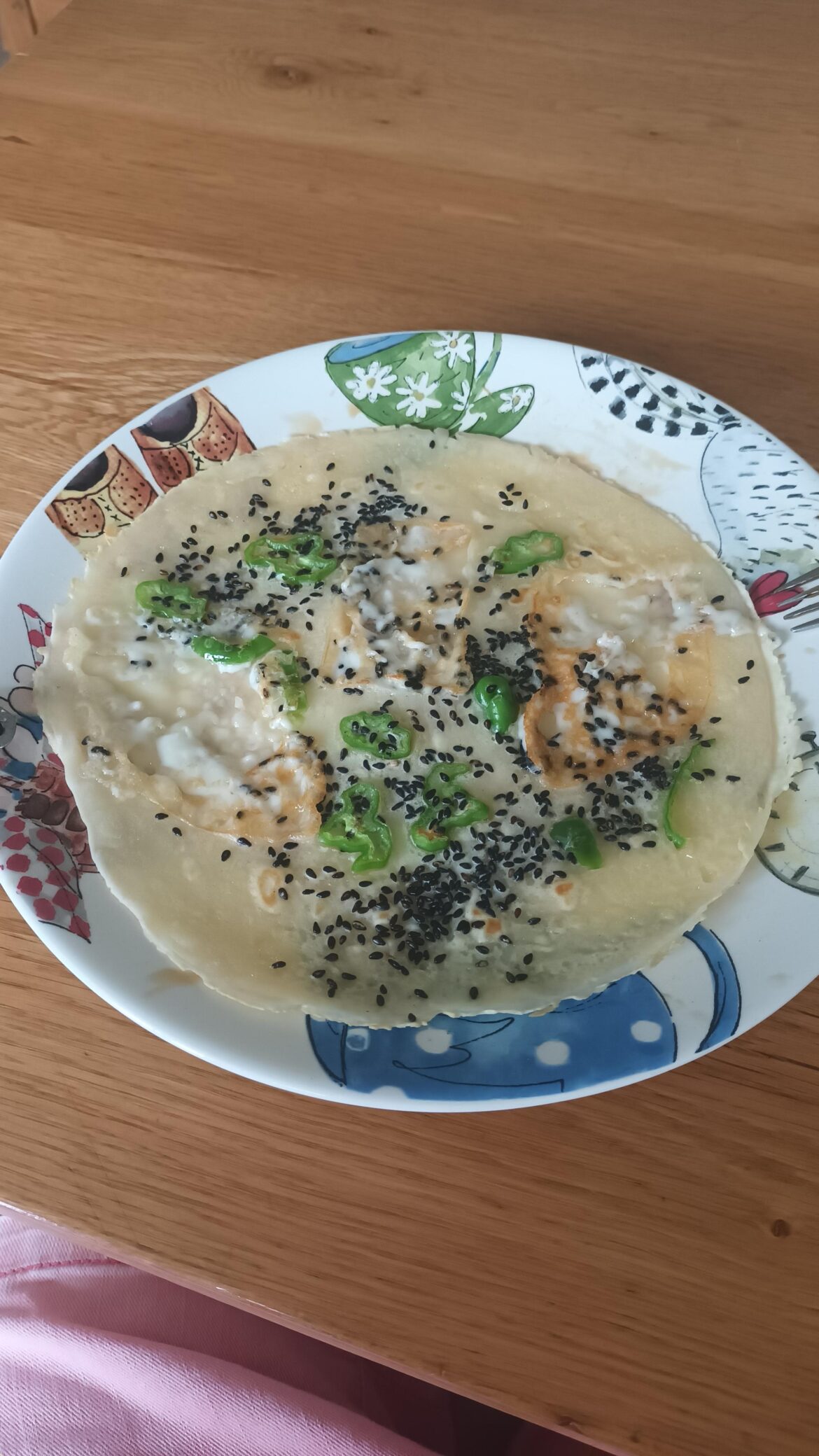 Homemade gluten free pancakes with goat cheese, homegrown shishito peppers, and sesame seeds