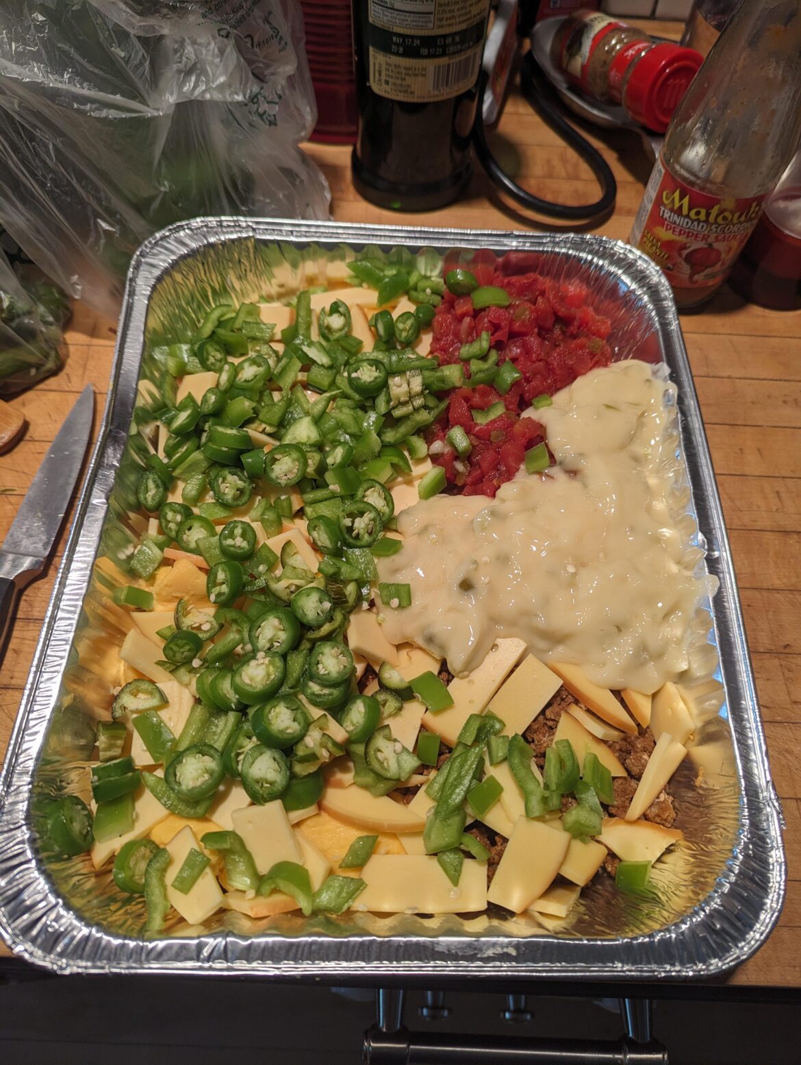 5 Serranos, 3 Jalapenos, 2 Anaheims + Spicy Chorizo Queso headed for the smoker