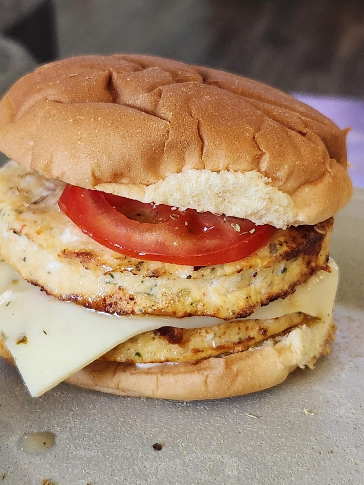 Double Mediterranean Greek Chicken patty with jalapeno jack cheese and tomatoes.