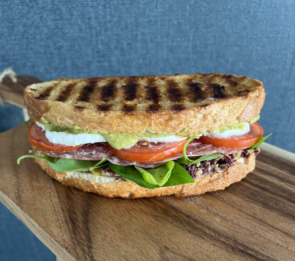 Salami Milano, mozzarella, tomato, olive tapenade, basil pesto and fresh basil on toasted sourdough.