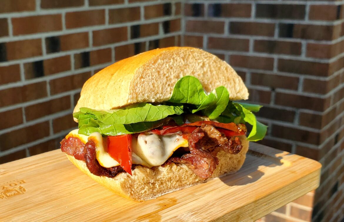 Charcoal grilled steak on homemade french bread with home grown arugula.