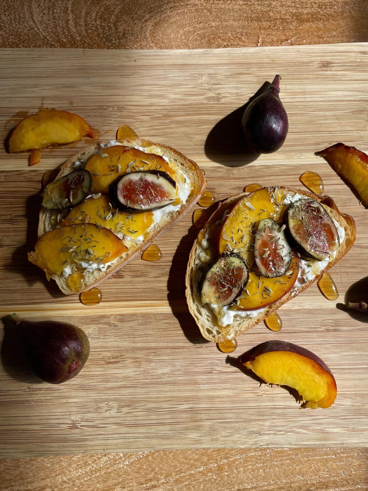 Figs and peaches on honey burrata toast with fennel and thyme