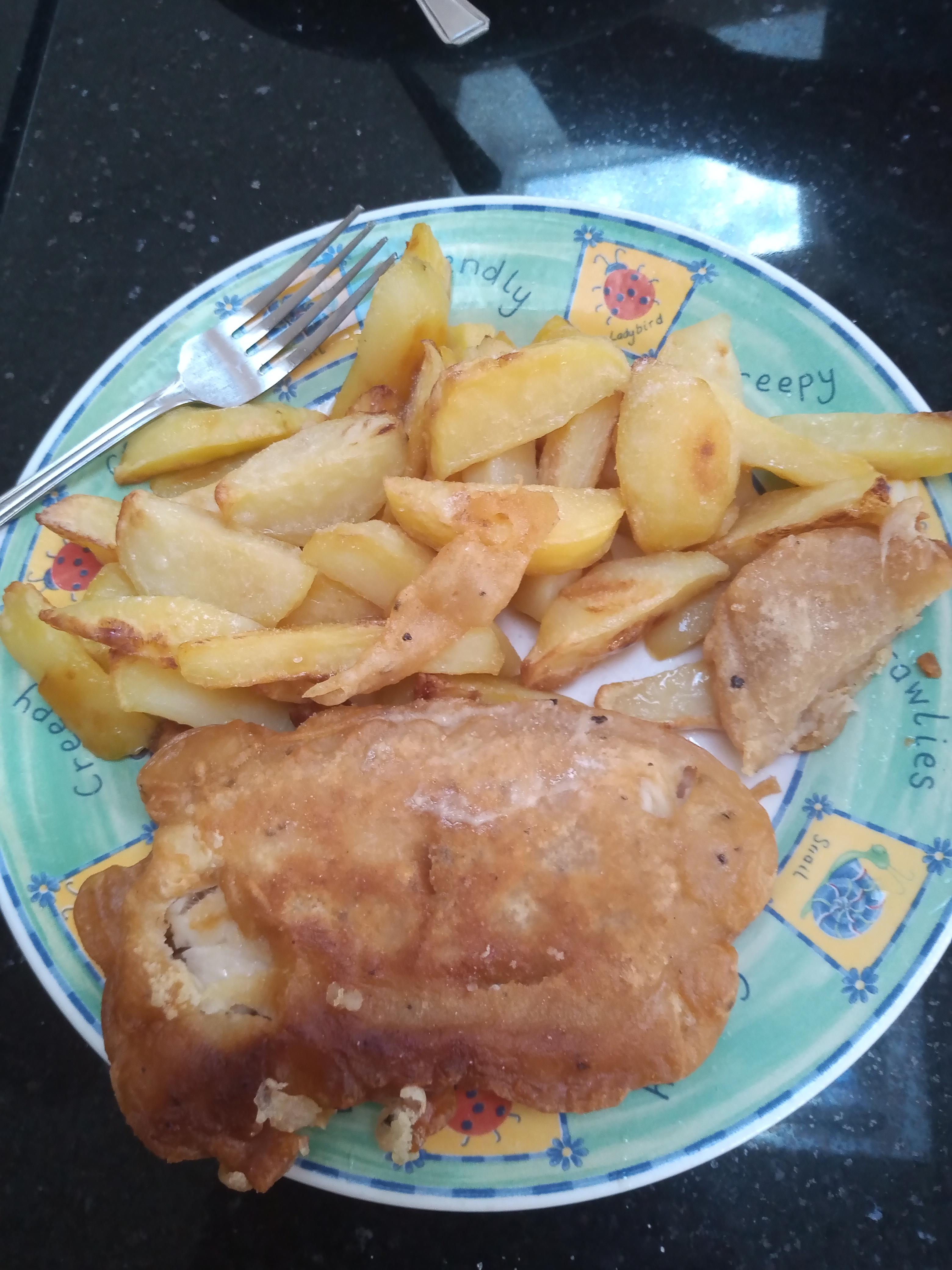 Homemade haddock and chips. Homebrewed beer used in the batter