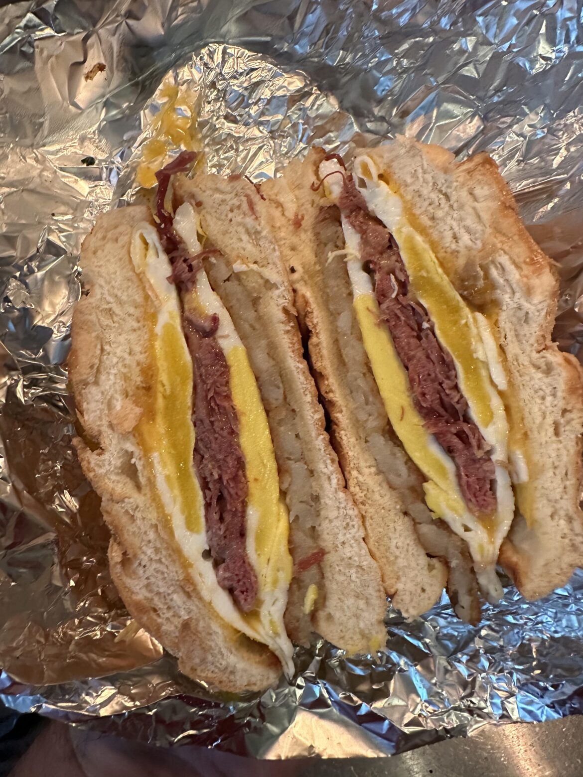 Egg, corned beef, hash brown patty and sharp cheddar breakfast sandwich
