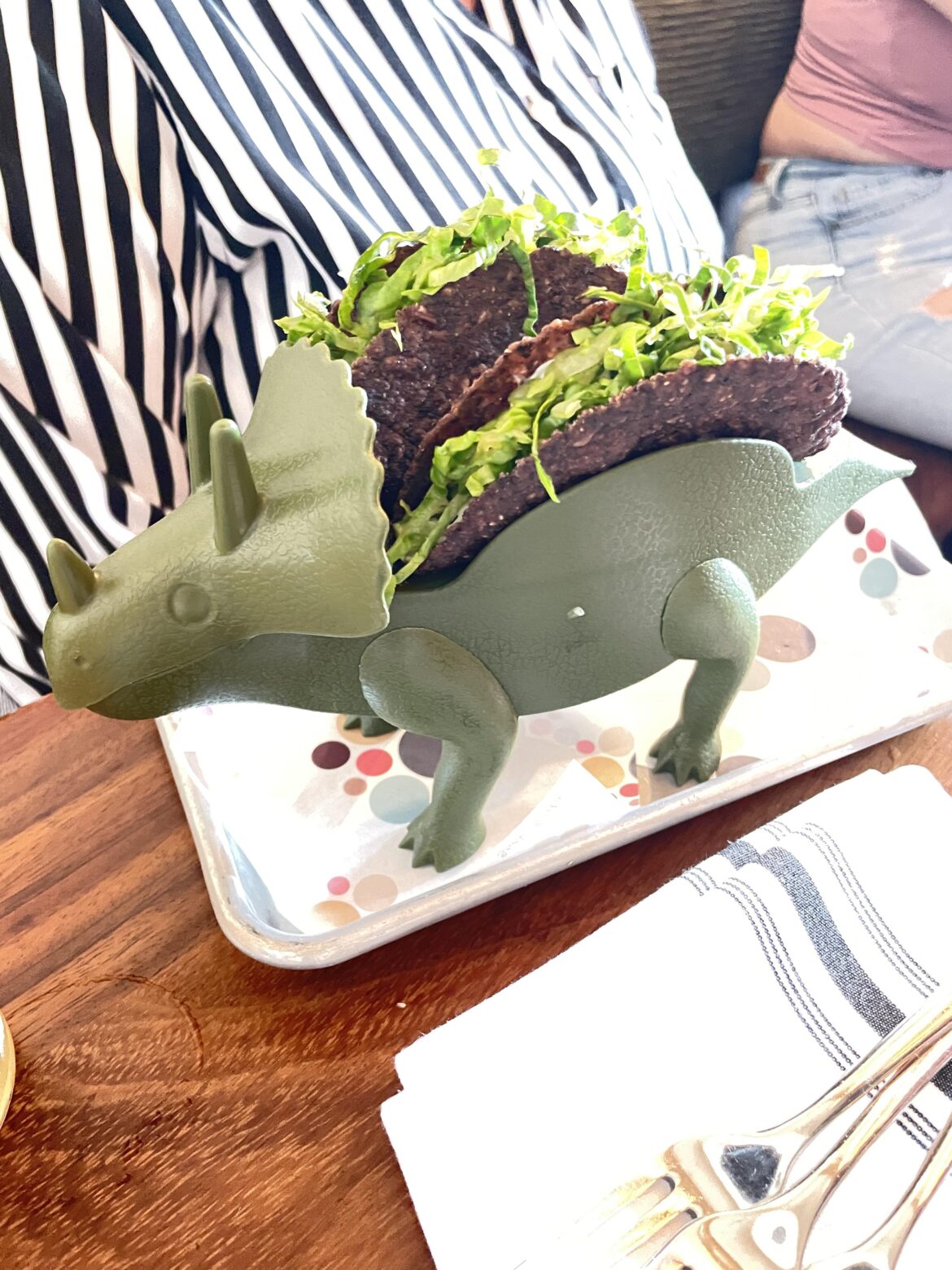 I wonder if the reason these 2 Taco Bell quality tacos served on a dinosaur were the reason they costed $15.