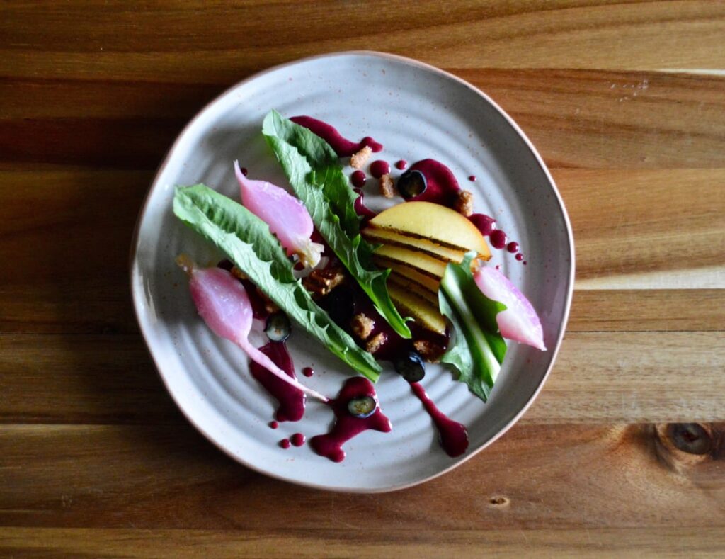 Charred Nectarine. Fermented Blueberry Vinaigrette. Confit Radish. Dandelion Greens. Candied Pecan.