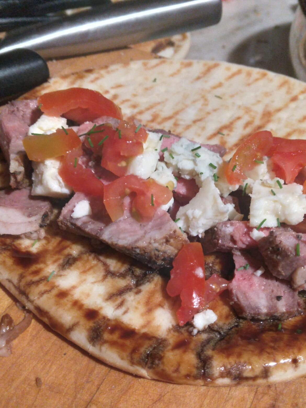 Steak,blue cheese, grape tomatoes,chives on pita(used to mop up balsamic reduction from the pan)
