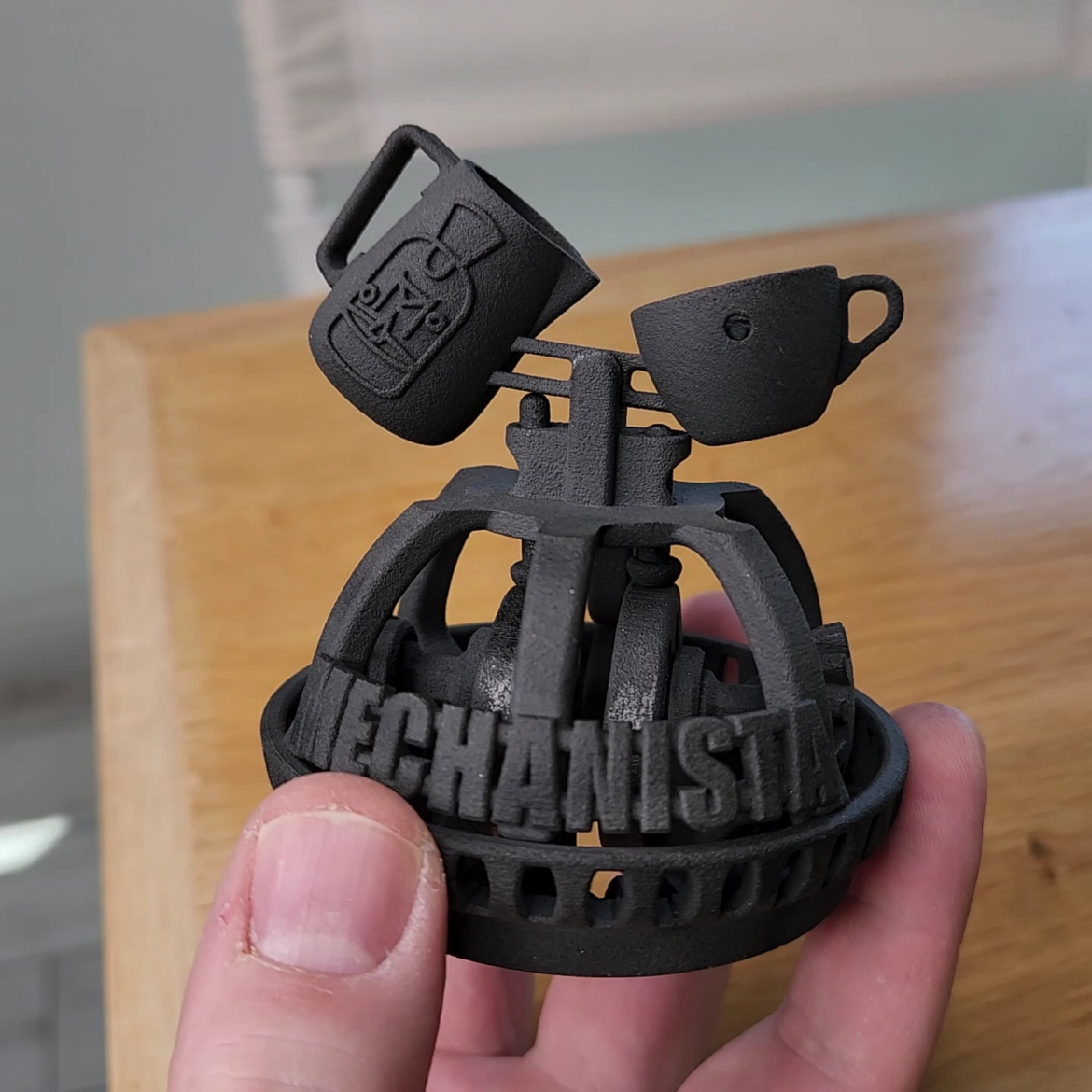 Here is a Latte Art pouring Automaton I designed and 3D printed as one part. It even features sloshing foam!