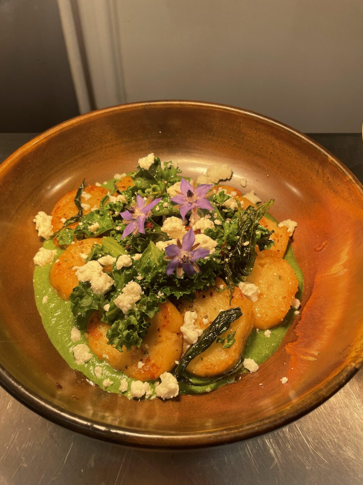 Wild garlic pan fried gnocci, spinach and bay purée, kale, samphire, goats curd, kohlrabi crisps and borage flowers
