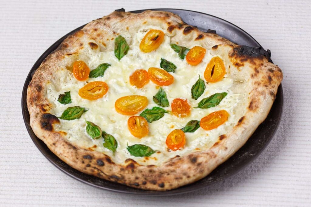My favourite dessert pizza. Ricotta, fior di latte, caramelised and flambéed kumquats.