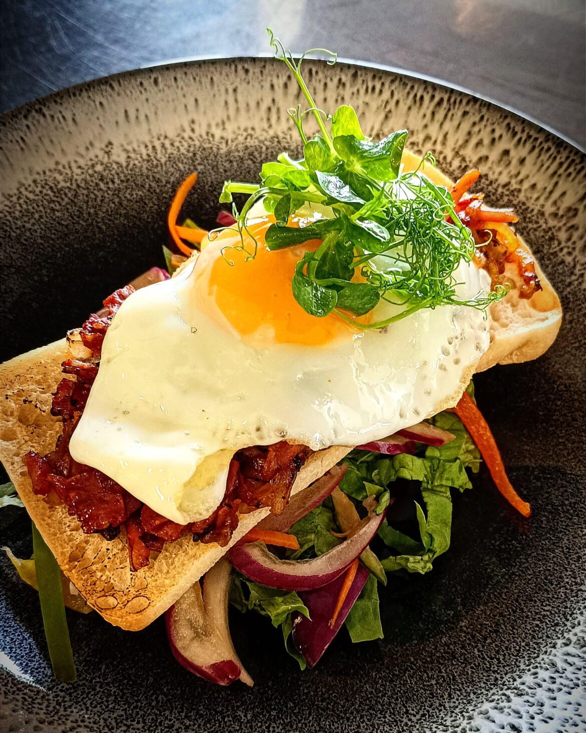 Ciabatta with chorizo and bacon topped with fried egg