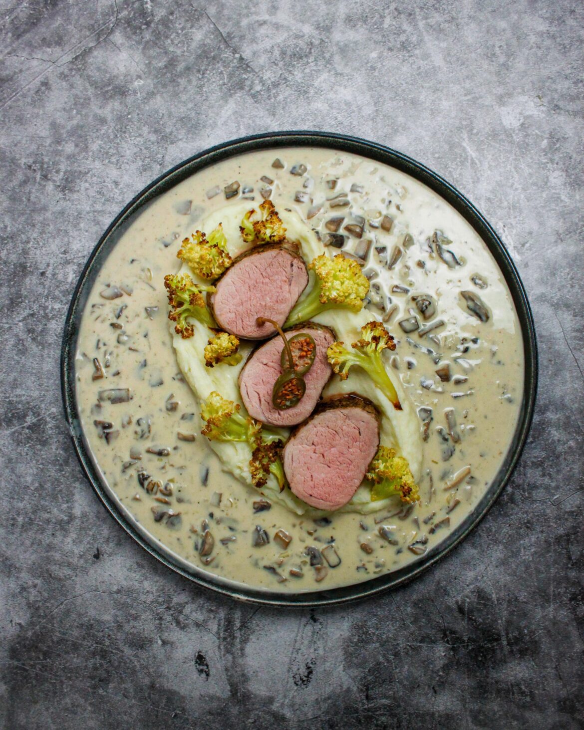 Porkntenderloin, whipped potatoes, roasted cauliflower, mushroom & shallot sauce