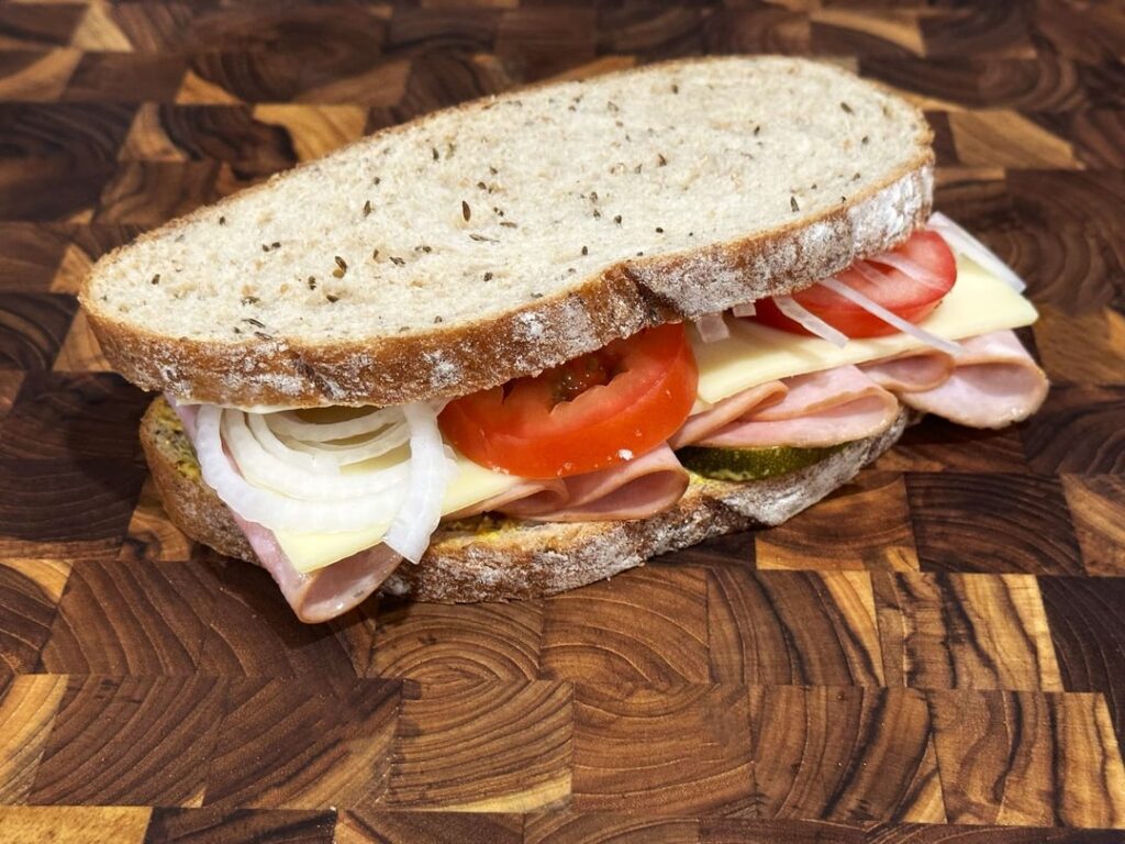 honey ham and swiss on rye w/ tomato, onion, spicy pickled zucchini, mayo and spicy brown mustard.