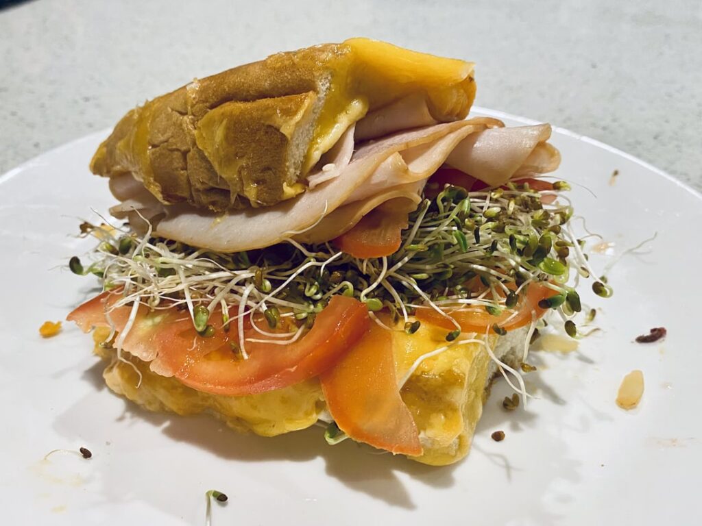 Turkey tomato cheddar sprouts sammie on a french bread heel