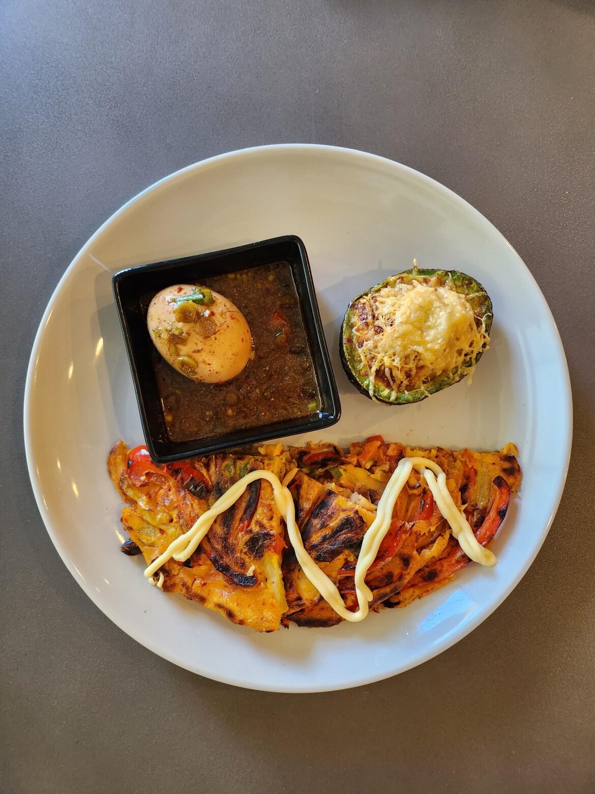 Made Kimchi pancake with veggies and a mayak egg that is also being used as dipping sauce for the pancake and air fried avocado with egg and seasoning, want to check off all the macros and probiotics. (Korean recipe Newbie here)