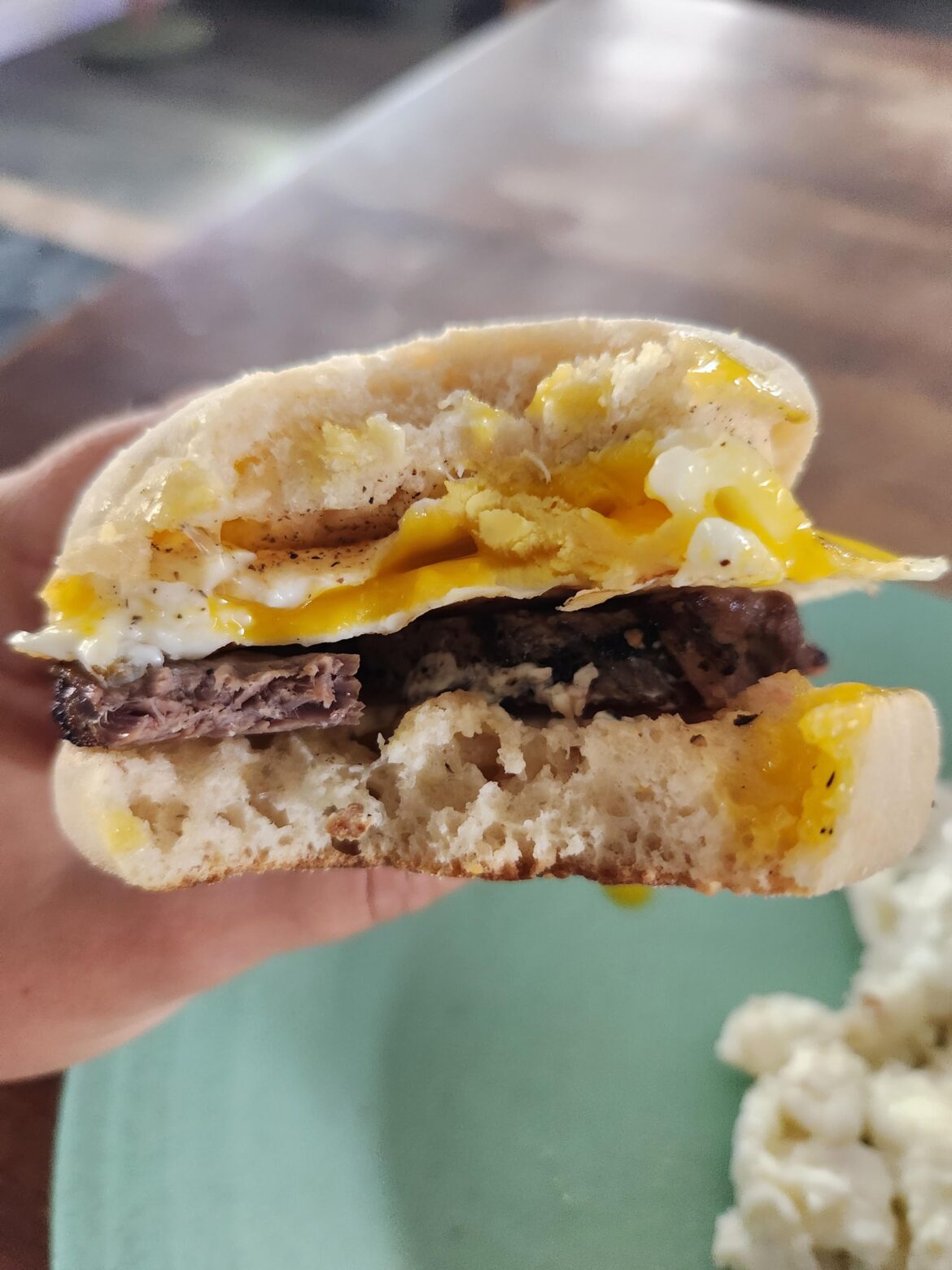NY Strip steak and egg breakfast sandwich on an English muffin