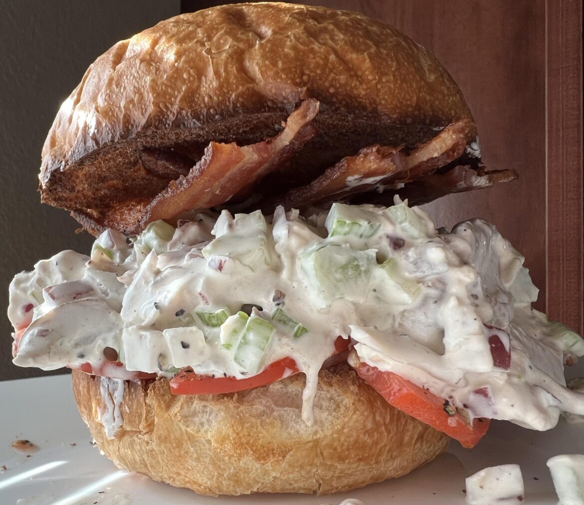 Chicken salad, bacon, and tomato on a toasted Kaiser roll