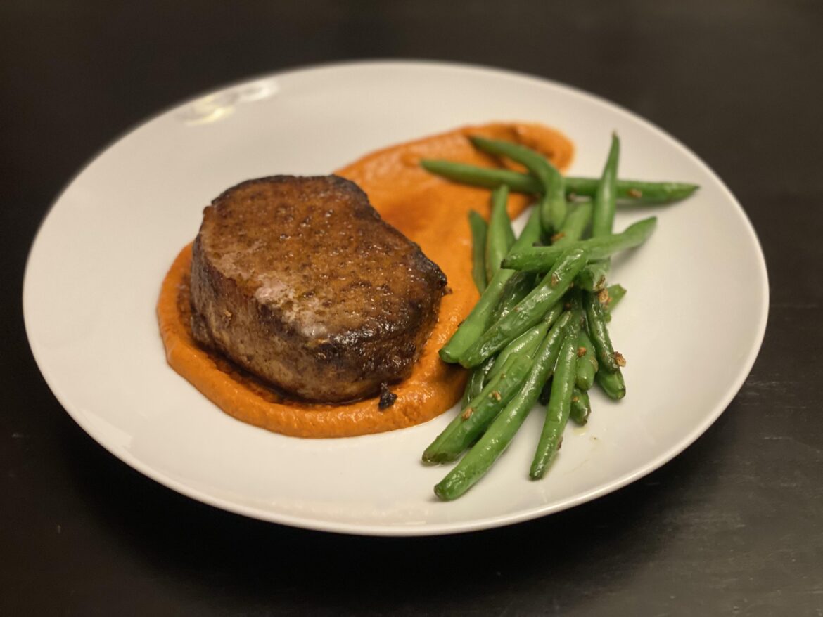 Seared Cumin-Dusted Pork Chop with Romesco and Garlic Beans