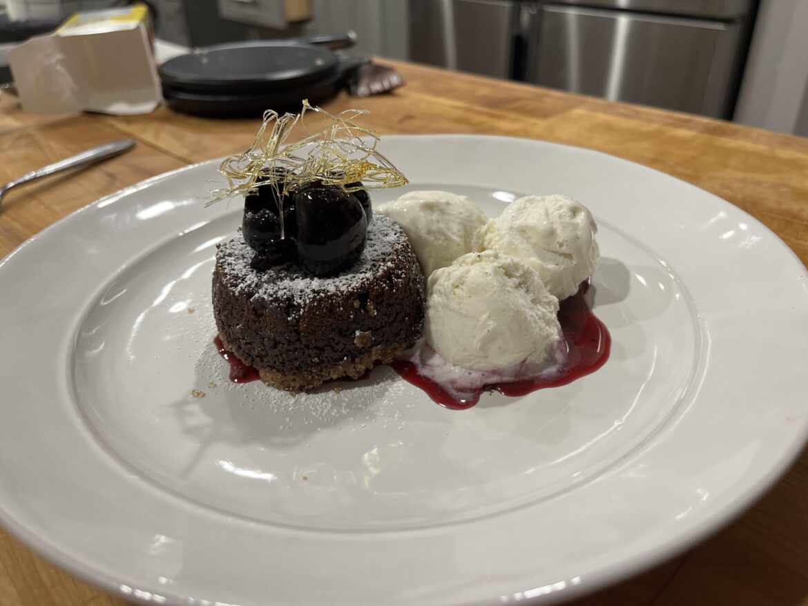 [line cook]60% Dark chocolate lava cake served with sweetened bing cherries vanilla ice cream and a caramelized sugar nest