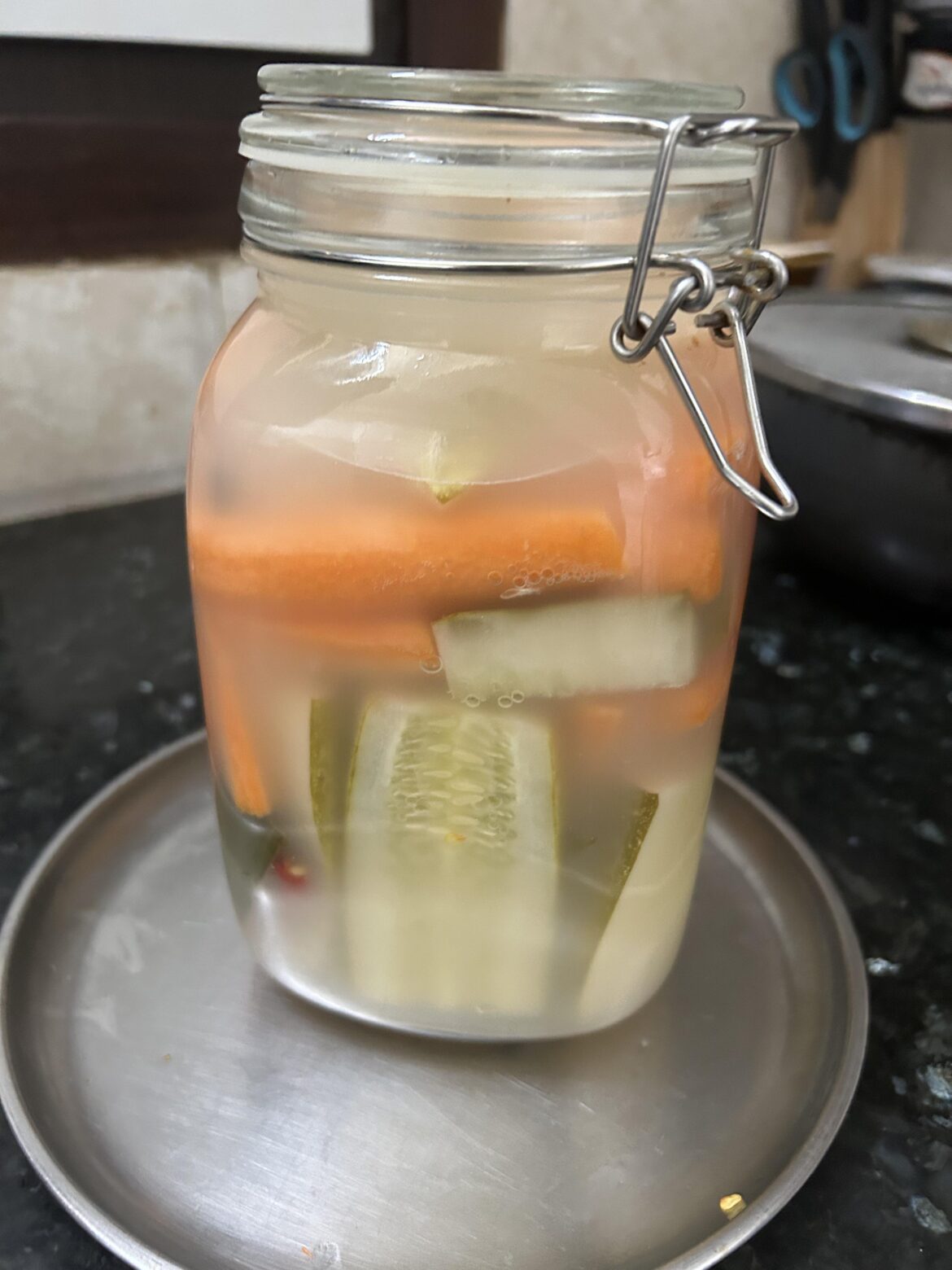 Day 3 of carrot cucumber fermentation with red chillies, pepper and black peppercorns. Cloudy bubbly brine. Good sign :)