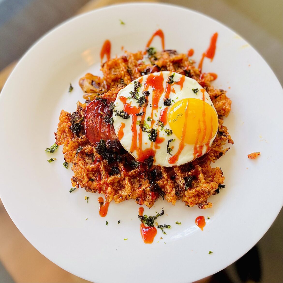 Kimchi Fried Rice Waffle- topped with fried spam, egg, and drizzled with Cho-Gochujang.
