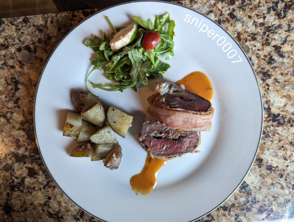 Venison tenderloin stuffed with rosemary, thyme, tarragon, sage and goat cheese, rubbed with Dijon mustard, coarse black truffle sea salt and crushed black peppercorns, wrapped with bacon and basted with butter... Laying in a chipotle butter cream sauce.