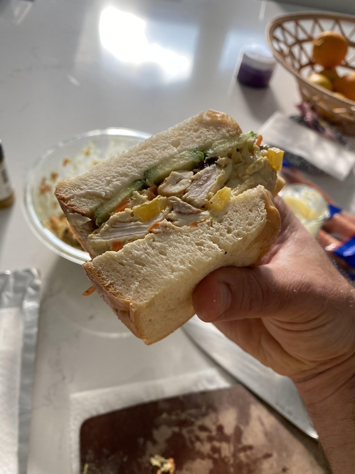 Curry chicken sandwich on challah with cucumber