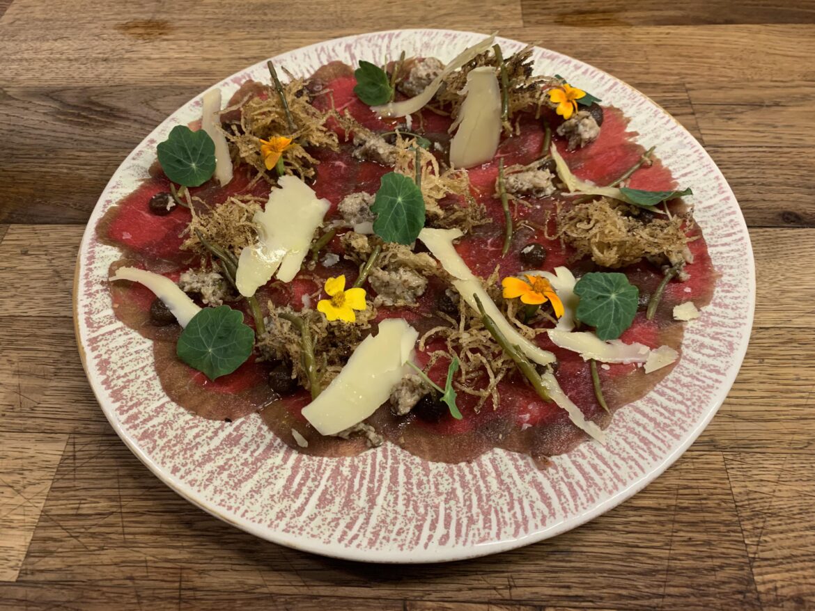 Bison Carpaccio, smoked shiitake duxelle, sea asparagus “capers”, pickled currant gel, fermented & fried potato frisée dusted with black allium, lankkaster Gouda, sexy EVOO