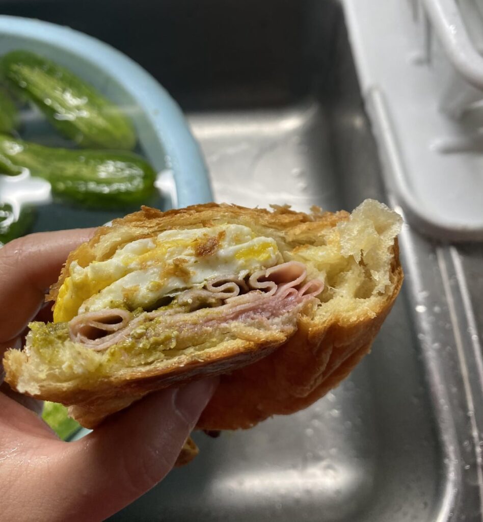 Ham, Salami , egg and pesto Croissant breakfast sandwich