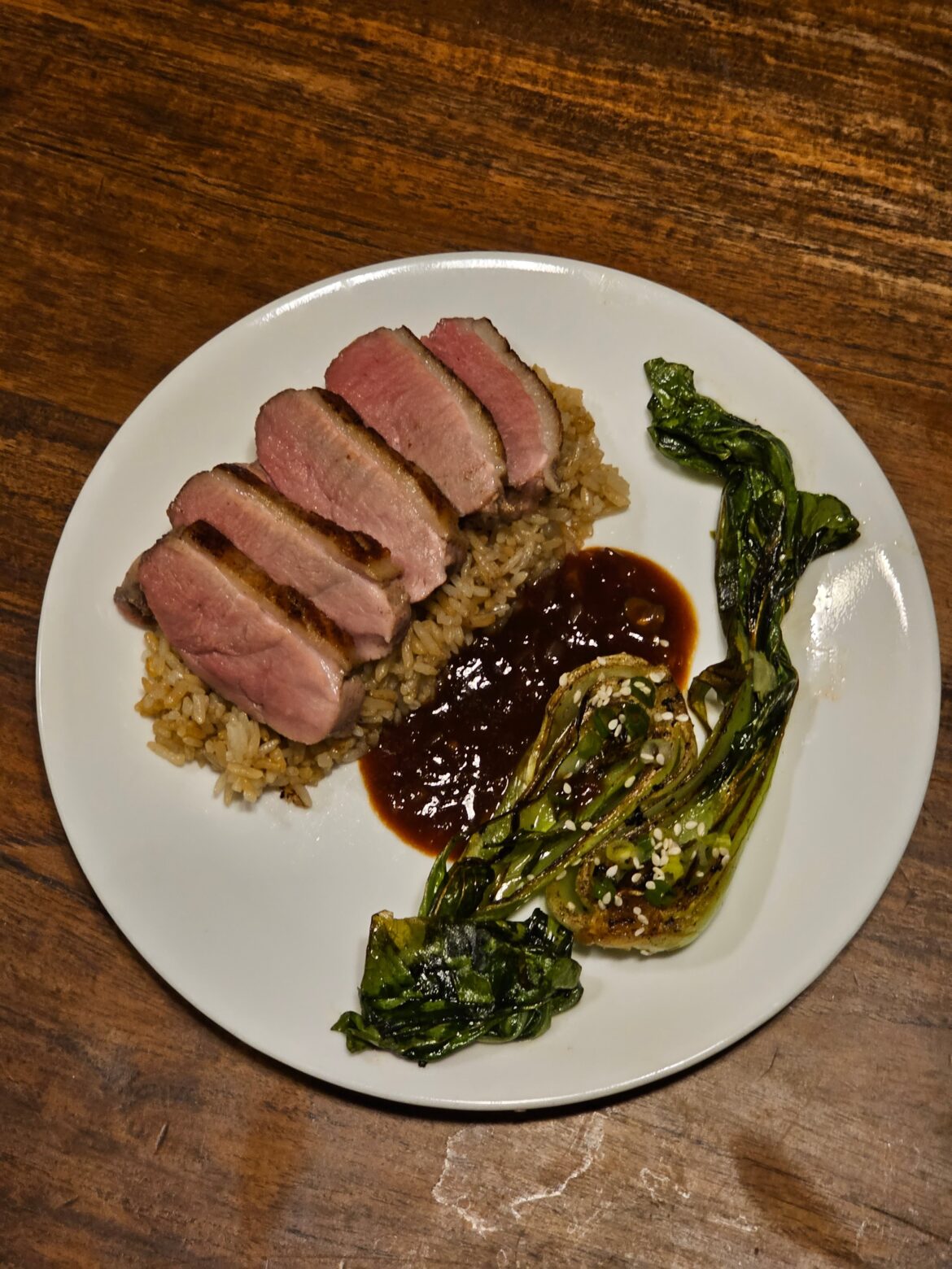 Shio Koji duck breast, seared bok Choy, duck fat fried rice and mandarin hoisin sauce