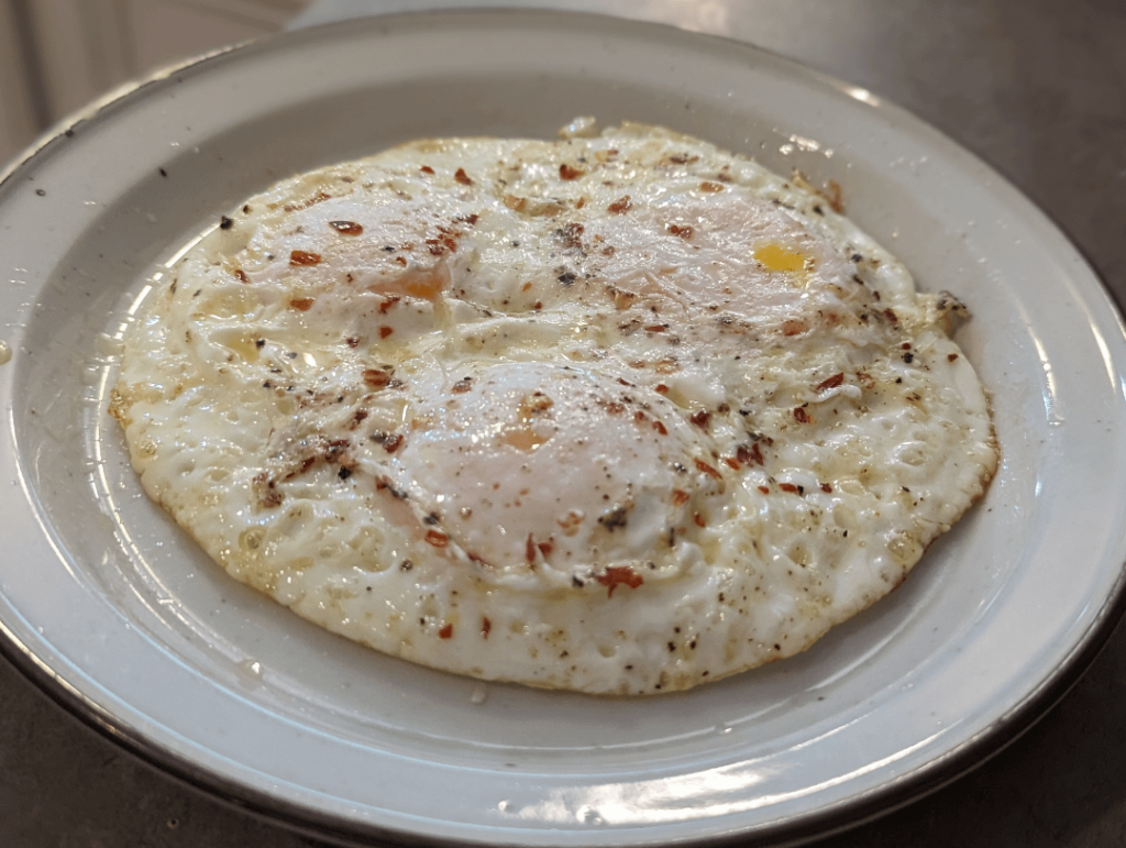Eggs on plate with crushed red pepper