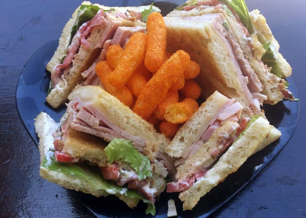 Extra Large Ham, Chicken, Bacon, and Double Swiss Club on Grilled Sourdough with Carolina Reaper Cheezy Poofs. Bread, bacon, and chicken loaf all home made from scratch.