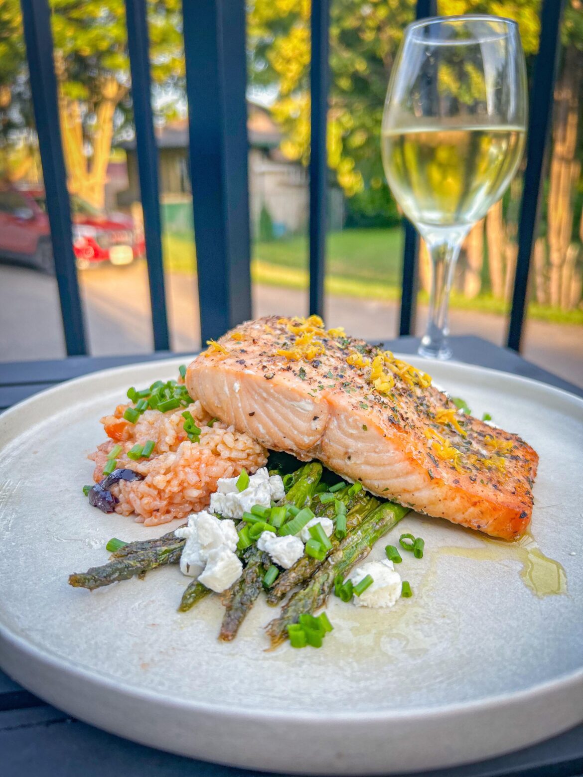 Baked salmon with pompodoro rice and asparagus, topped with honey goat cheese