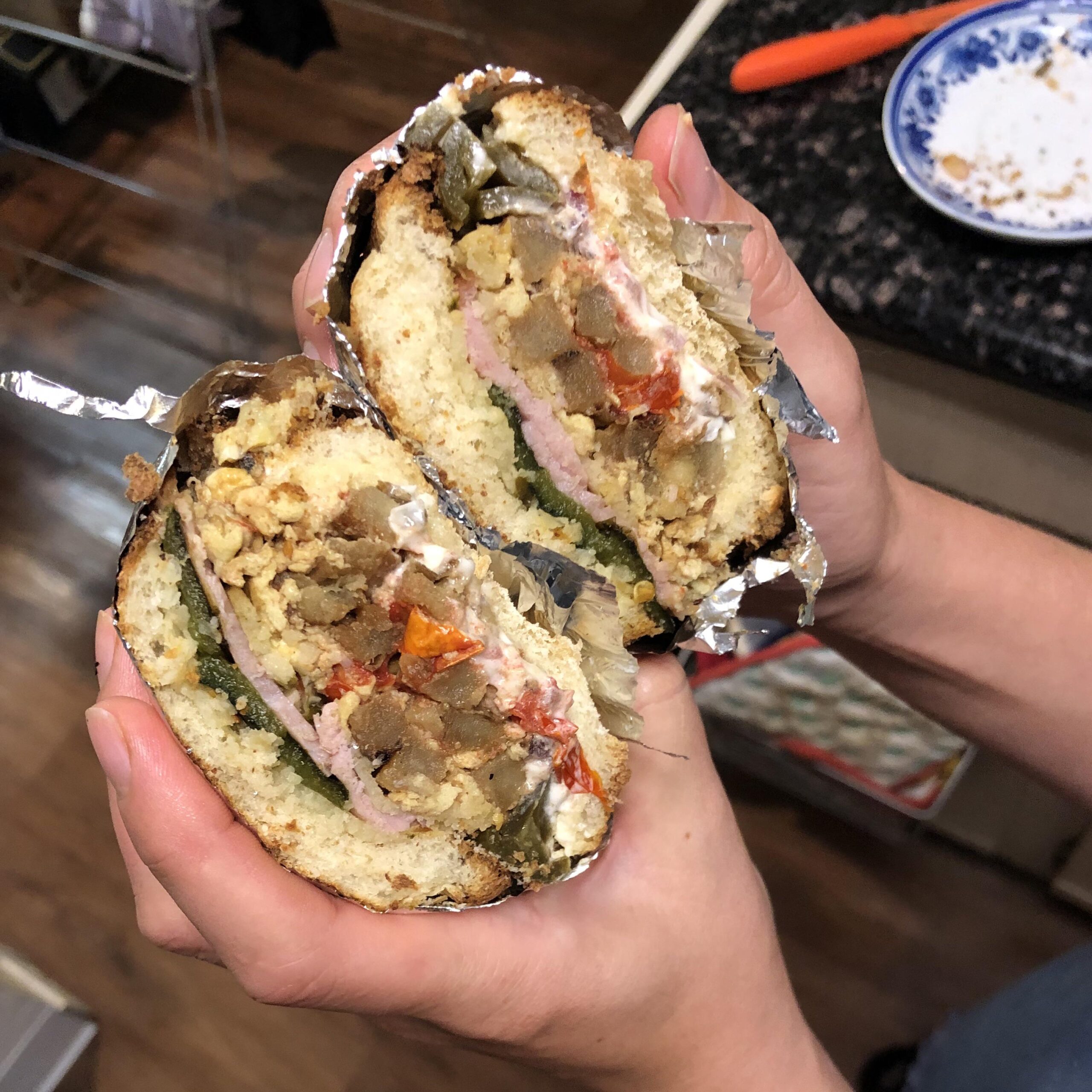 Torta with ham, French fries, scrambled egg, pickled jalapeños, poblano