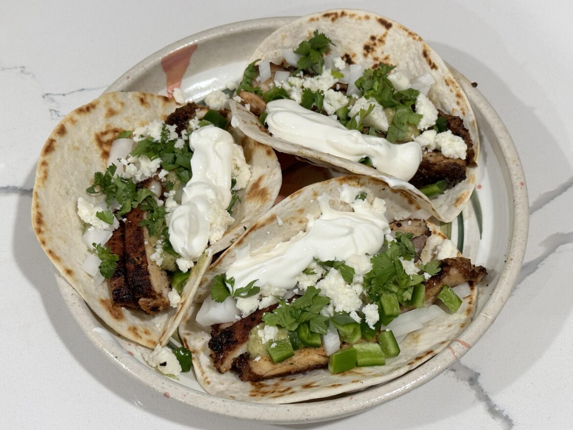 chicken tacos w/queso fresco, onion, jalapeño, cilantro, sour cream and homemade serrano hot sauce