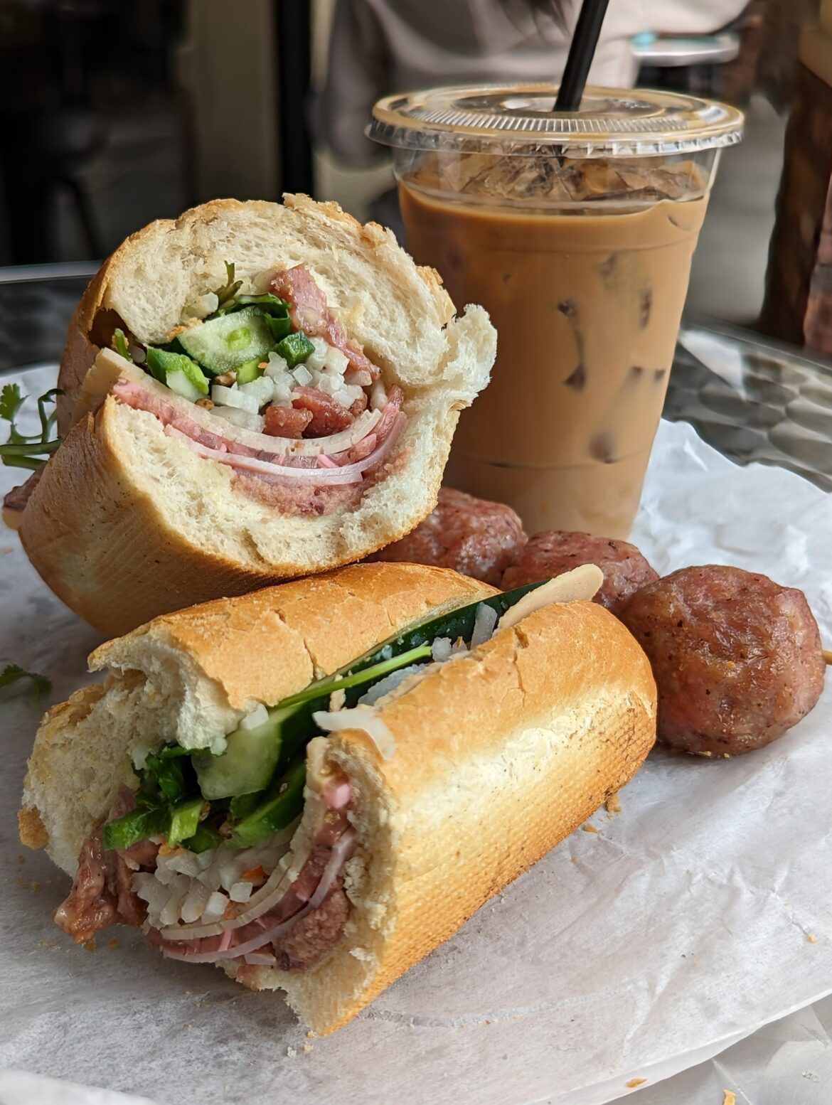 Banh Mi Dac Biet from Banh Mi My Tho, with a side of meatballs and a Vietnamese coffee.